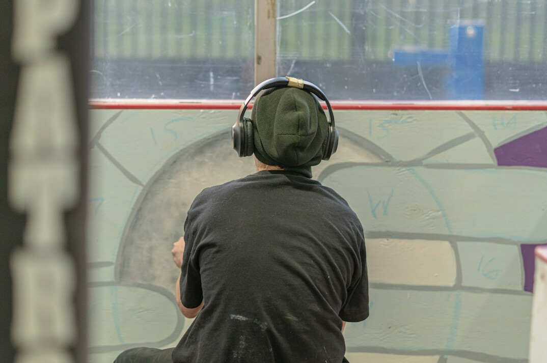 Coach training a presenter with a headset in a one-on-one session
