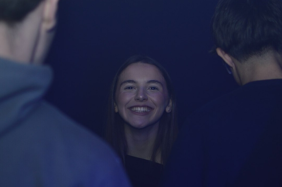 Mediator speaking quietly with two people backstage